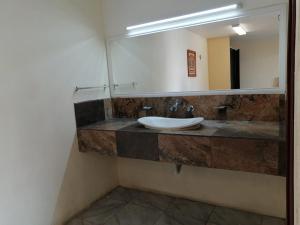 a bathroom with a sink and a mirror at Hotel Bugambilia Campeche in Campeche