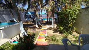 a garden with a colorful sidewalk next to a pool at Villa mar in Puerto Colombia