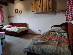 A bed or beds in a room at András penzión