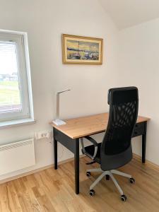 a desk with a chair and a computer on it at Avio rooms in Cerklje na Gorenjskem