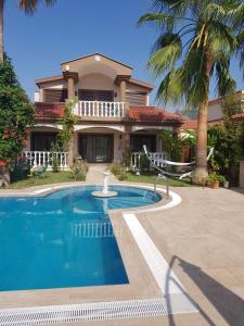 a house with a swimming pool in front of a house at Villa Bade in Dalyan