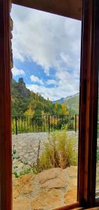 a window looking out at a view of a field at Saluda Alta in Castril
