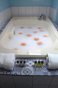 a bath tub with orange flowers in it at Alebrije Hotel Boutique in Guadalajara