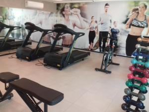 a group of people on exercise bikes in a gym at Acomodação Tranquila (Centro de Campos) in Campos dos Goytacazes