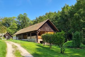 a barn with a dirt road in front of it at Apartment Vintgar in Slovenska Bistrica