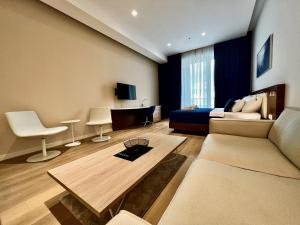 a living room with a couch and a bed at Condo Studio Plaza in Budva