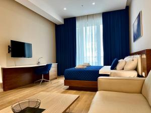 a hotel room with a bed and a television at Condo Studio Plaza in Budva