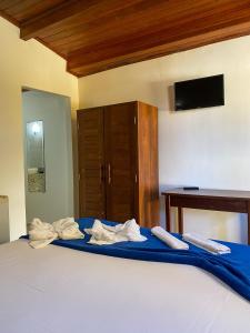 Hotel e Pousada Tetiaroa tesisinde bir odada yatak veya yataklar