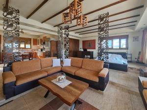a living room with a couch and a table at Colonial View Apartment in Faliraki