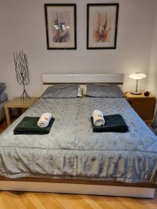 a bedroom with a bed with two towels on it at W Kolorze Mięty in Warsaw