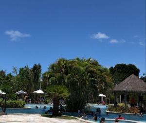 a group of people in a pool at a resort at Apartamento flat - Iloa Residence 1 in Barra de São Miguel