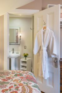 a bedroom with a robe hanging on a door at Sinclair Inn Bed & Breakfast in Jericho