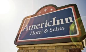 um sinal para um hotel e suites americanos em AmericInn by Wyndham Albert Lea em Albert Lea