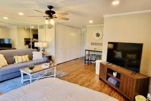 a living room with a couch and a flat screen tv at Lakeside Villa - Quite Location, walk to the pool and to the Country Club in Diamondhead
