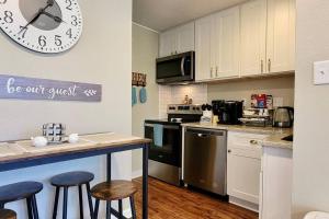 a kitchen with a counter and a clock on the wall at Lakeside Villa - Quite Location, walk to the pool and to the Country Club in Diamondhead