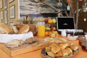 a table with a bunch of bread and other foods at Petani Bay Hotel - Adults Only in Vovikes