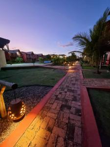 a cobblestone walkway with a lantern on it at night at Chaleville Coqueiro 1001 in Luis Correia