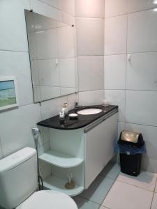 a bathroom with a sink and a toilet at Chaleville Coqueiro 1001 in Luis Correia