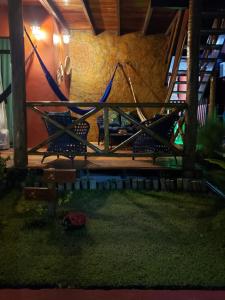 a model of a house with a hammock in a yard at Chaleville Coqueiro 1001 in Luis Correia