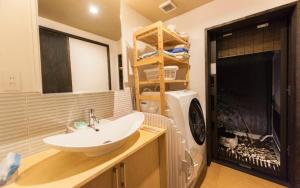 a bathroom with a sink and a washing machine at Hotel Zipangu Tameikecho in Kyoto +22 photos