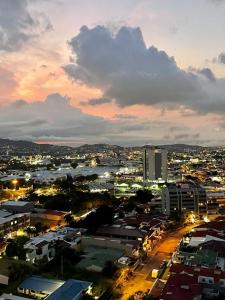 a city at night with buildings and lights at Amazing views SJO, Cozy, Equipped. 24/7 Concierge in San José