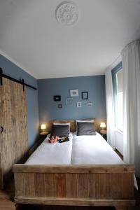 a bedroom with a large bed with a wooden frame at Oekepoek Down Town in Enschede