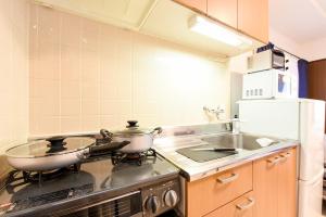 a kitchen with a stove with two pots on it at Northwest IR Room 201 - Vacation STAY 8477 in Sapporo