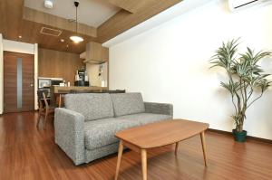 a living room with a couch and a table at Hills Garden Hondori / Vacation STAY 7577 in Sapporo