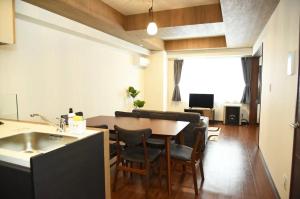 a kitchen and living room with a table and chairs at Hills Garden Hondori / Vacation STAY 7576 in Sapporo