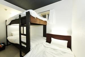 a bunk bed in a room with two beds at Heights N7 / Vacation STAY 7573 in Sapporo
