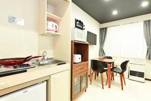 a kitchen and dining room with a table and chairs at Heights N7 / Vacation STAY 7573 in Sapporo