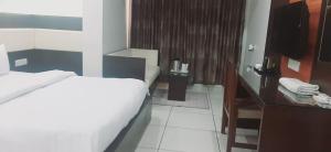 A bed or beds in a room at Hotel Apex Inn