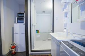 a white kitchen with a refrigerator and a sink at Suncourt Maruyama Goden Hills / Vacation STAY 7605 in Sapporo