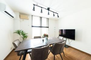 a dining room with a table and chairs at Hongo Street House - Vacation STAY 8636 in Sapporo