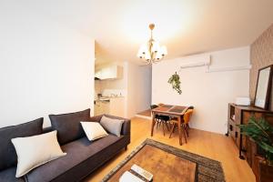 a living room with a couch and a table at Sapporo - Apartment - Vacation STAY 7939 in Sapporo
