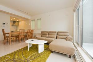 a living room with a couch and a table at Private House S12 - Vacation STAY 87118 in Sapporo