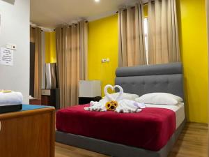 - une chambre avec un lit et une couverture rouge dans l'établissement Samudera Hotel, à Kampung Kuala Besut