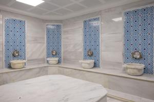 a room with three toilets and blue tiles at ES TERMAL OTEL&SPA in Derekoy +22 photos