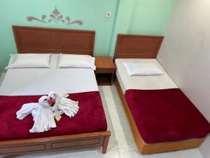 Postel nebo postele na pokoji v ubytování Samudera Hotel