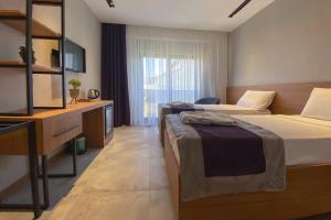 a hotel room with two beds and a television at ES TERMAL OTEL&SPA in Derekoy