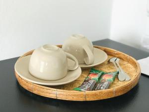 a tray with a tea pot and tea bags on a table at บ้านพักดีมีทรัพย์ Baan PakDee Meesub in Uthai Thani