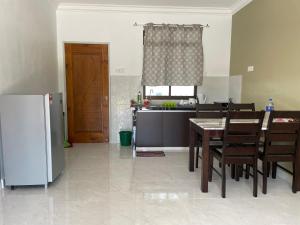 珍南海灘的住宿－Laura Guest House Langkawi，厨房配有桌子和冰箱