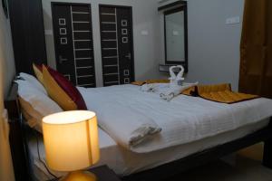 Postel nebo postele na pokoji v ubytování Hotel Akshith Inn