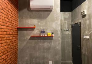 a bathroom with a wall with a shelf on it at Hotel EC KIP Sentral KLIA 1 - KLIA 2 in Sepang