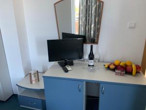 a desk with a computer on it with fruit on it at Guest House Briz in Nesebar