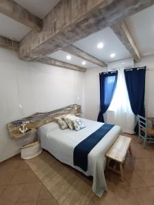a bedroom with a large bed with blue curtains at Chez Luis in Imperia +56 photos