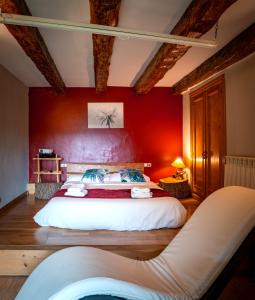 a bedroom with a bed, chair, lamp and a tv at Balcon del Pirineo Rural Ordesa in Buesa