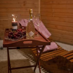 a table with two bottles and wine glasses on it at Domek Bogusza in Kamionka Wielka +18 photos
