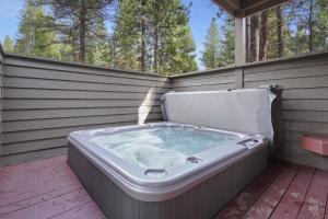 a jacuzzi tub sitting on a patio at 3 Tumalo with Wood Burning Fireplace in Sunriver