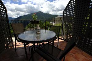 a dining room table with chairs and a patio at Balcon del Pirineo Rural Ordesa in Buesa